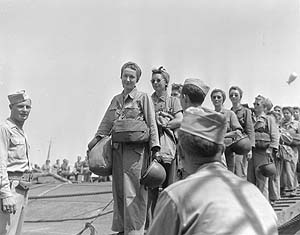 LT Mary Jane Hinckley of Millville, NJ and nurses of the 95th Evacuation Hospital being checked off the loading roster as they load on a ship that will take them to their unit on the invasion front on the southern coast of France.