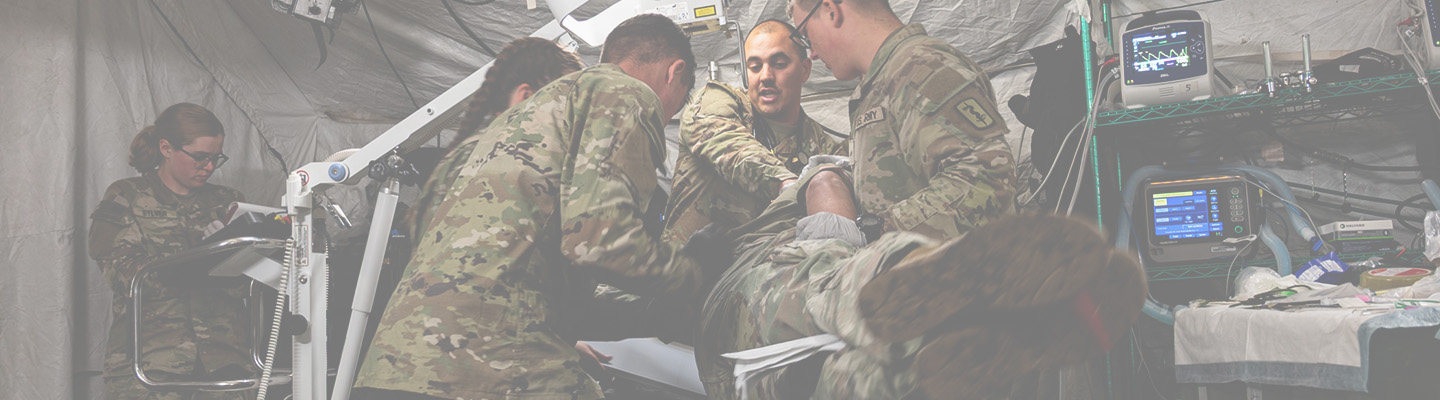 5 US Army medical soldiers treat a simulated casualty during a training exercise.